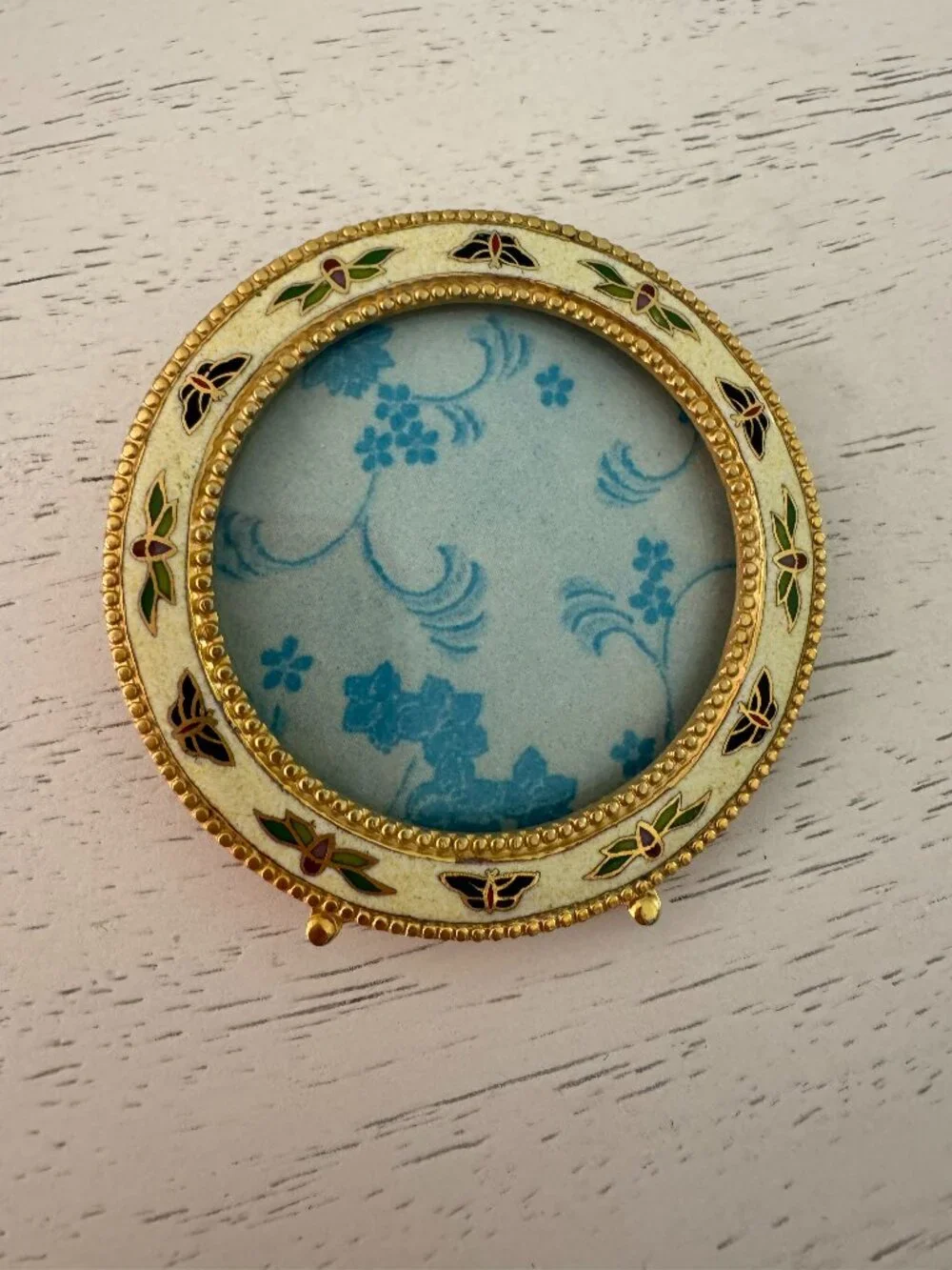 Vintage enamel picture frame with butterfly and floral theme